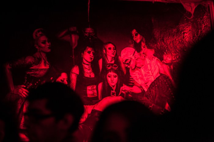 A group of goths in Mexico City under red club lights