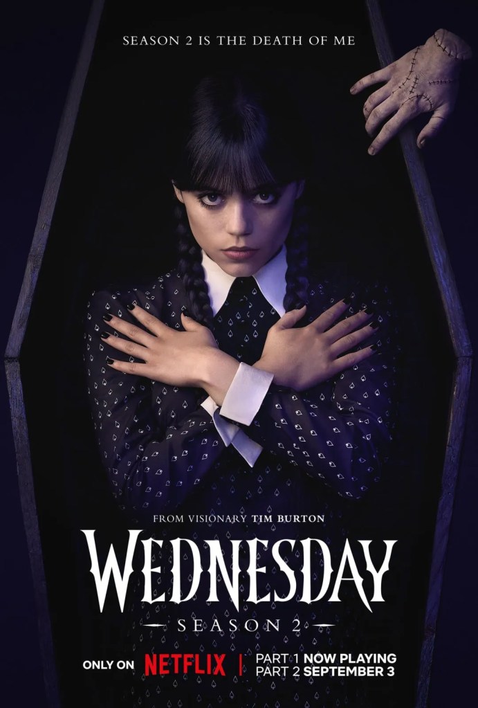 Jenna Ortega as Wednesday Addams, lying in a black coffin for a Season 2 promotional photo.
