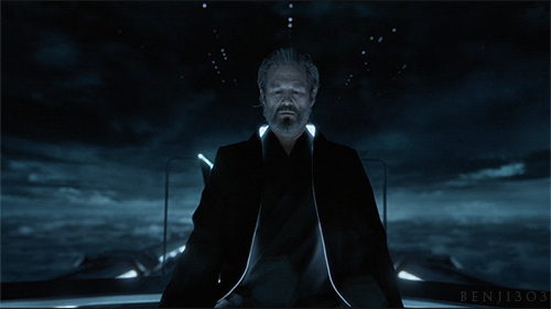 Kevin Flynn meditates in the soft blue light of his safehouse, isolated from the corrupted Grid he once hoped to perfect.