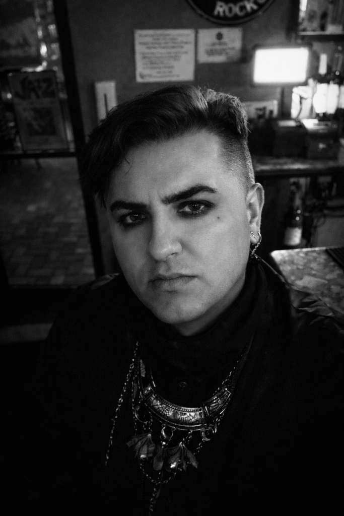 Black and white portrait of writer Ian Joseph, founder of The Twilight Tone, a journal focused on goth music, darkwave, and speculative fiction.